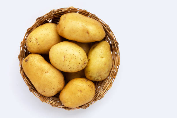 istock Fresh patatoes in bamboo basket on white background. 1362289962