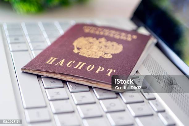Passport Of Russian Federation On A Gray Laptop Keyboard Identification Of The User On The Internet Prohibition Of Access To The Internet Without Passport Data Issuing A Passport Via The Internet Stock Photo - Download Image Now
