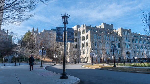 Boston College Boston, USA - December 23, 2021: Student walking around of Maloney Hall at Boston College, in Chestnut Hill, Massachusetts. boston college campus stock pictures, royalty-free photos & images