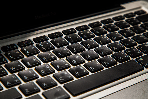 Close-up detail view of a laptop keyboard on the keys with high contrast and shallow depth of field. Computer keyboard, Selective focus.