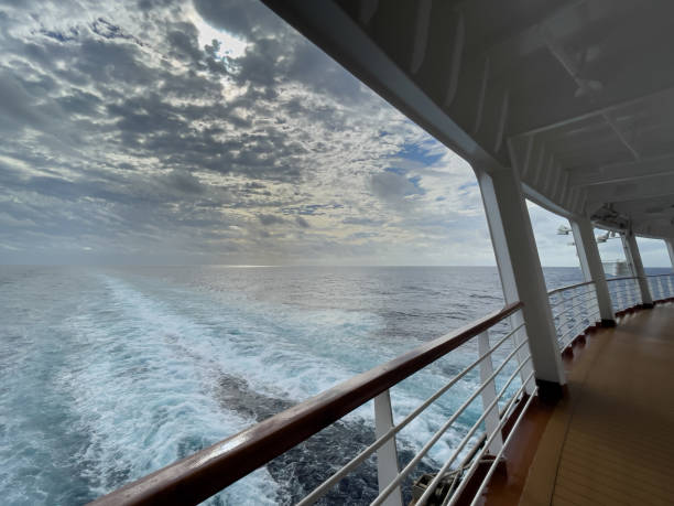 istock Back View of Sail Boat Deck with Prop Wash with Dramatic Sky 1362294972