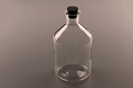 Empty bottle of unusual shape. Black and white photograph.