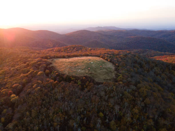 Sunset over a Grassy Bald Mountain in Western North Carolina in the Fall Aerial view of sunset over tents on a grassy mountain bald in the mountains of western North Carolina. huckleberry stock pictures, royalty-free photos & images