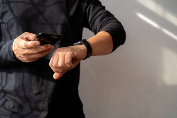 istock Man using smart watch and smart phone in office 1362303443