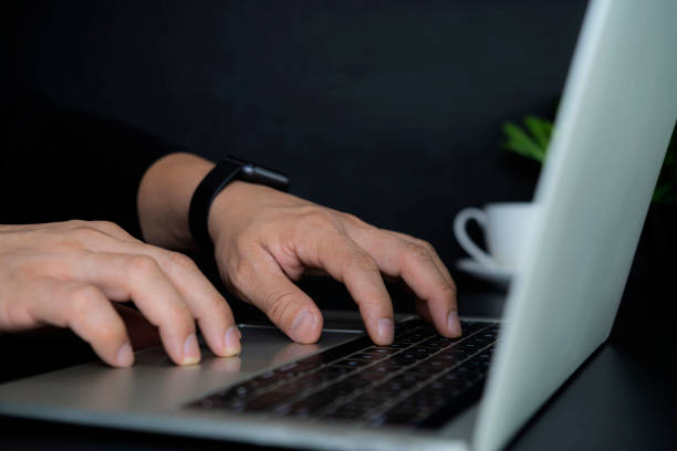 istock Close up of business man hands typing on laptop computer 1362305763