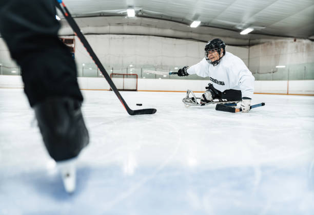 istock Latin woman and her trainer practising para hockey 1362306367