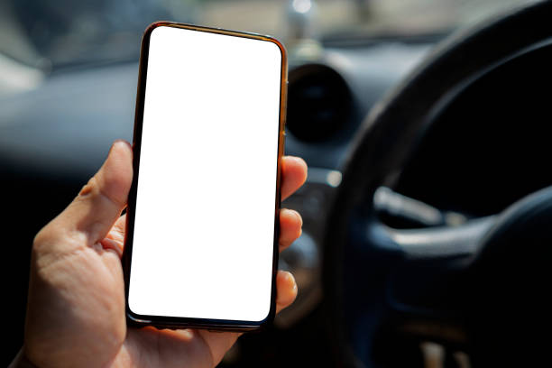 istock Cropped shot view The driver uses the phone while driving. 1362306410