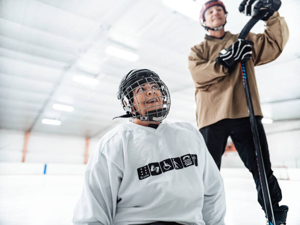 istock Latin woman and her trainer practising para hockey 1362306483