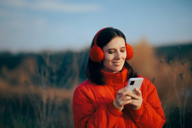 istock Winter Woman Checking her Phone in Outdoor Walk 1362308043