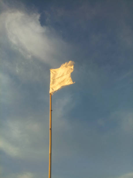 istock waving white flag against blue sky background 1362308203