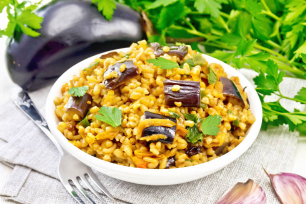 istock Bulgur with eggplant in bowl on white board 1362308266