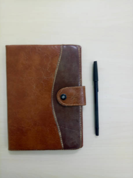 istock old notebook with pen. notebook on white wooden background with copy space area 1362309011