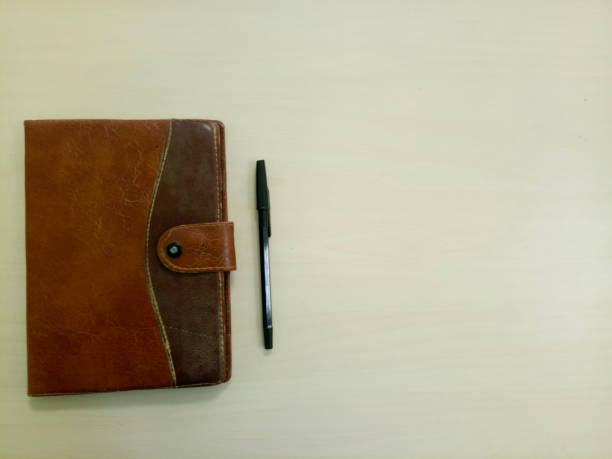 istock old notebook with pen. notebook on white wooden background with copy space area 1362309066