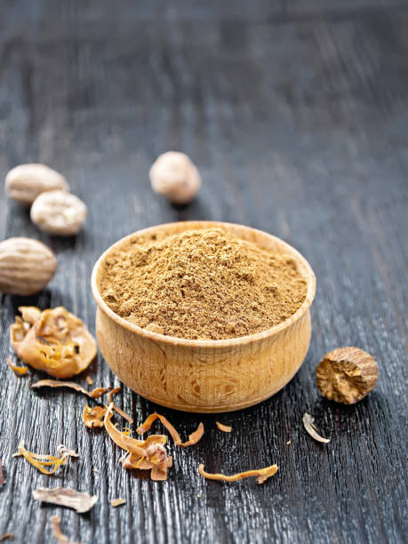 istock Nutmeg ground in bowl on black wooden board 1362309709
