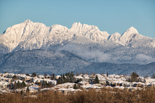 Fraser river and Coquitlam City seen from Surrey in winter 2021 .  Extreme low temperatures were recorded in 2021 winter in BC.