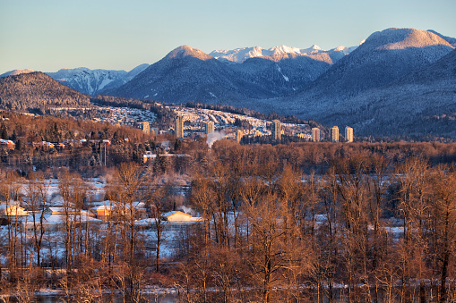 Fraser river and Coquitlam City seen from Surrey in winter 2021 .  Extreme low temperatures were recorded in 2021 winter in BC.