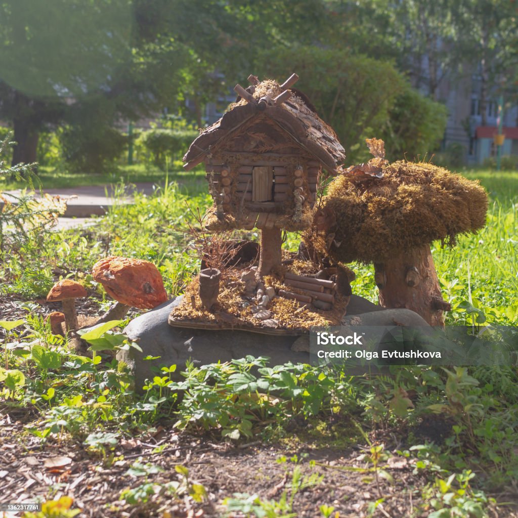 Wooden little house of a fabulous creature in the park in summer Wooden little house of a fabulous creature in the park in summer. Fairy Stock Photo