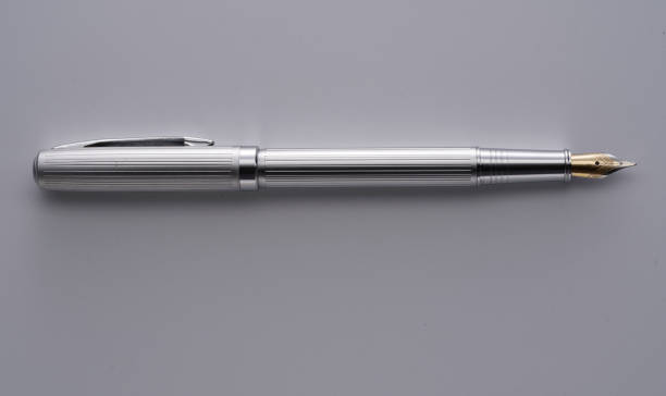 istock silver fountain pen on gray background 1362320193