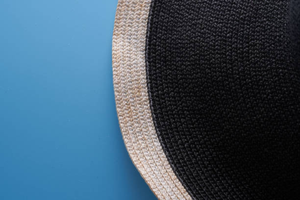woman black straw sun hat  on blue background