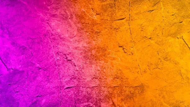 Photo of Yellow orange magenta purple. Gradient. Painted stone surface texture. Abstract colorful background