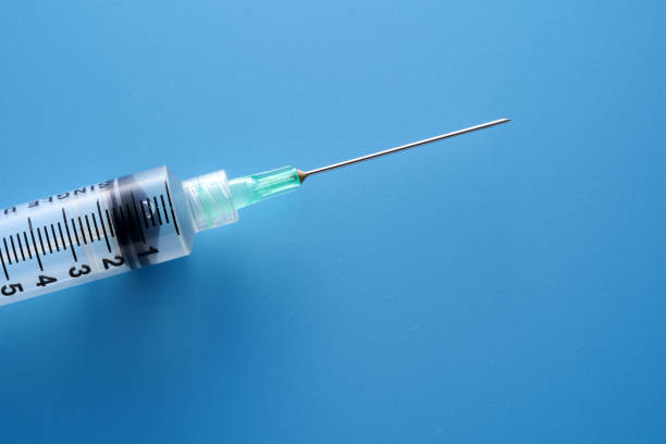 istock covid 19 vaccine on blue background 1362321146