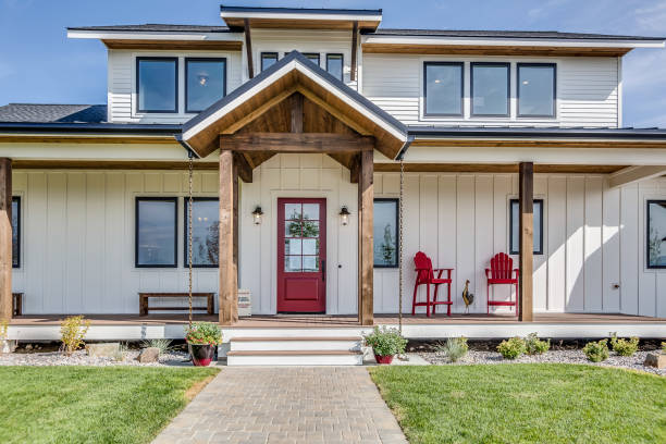 istock Black trim windows and red front door on white house 1362324767