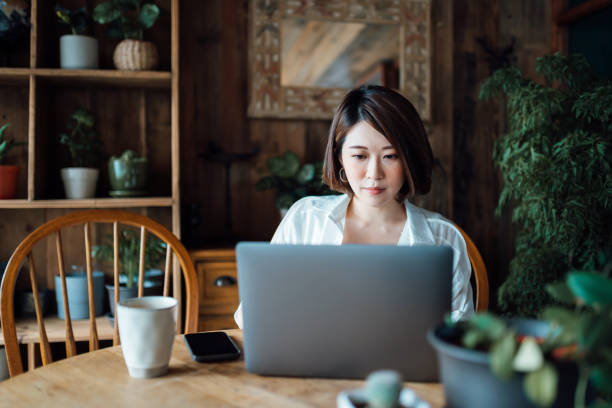 istock Confident young Asian businesswoman working from home using laptop computer in home office. Remote working, freelancer, small business concept 1362328413