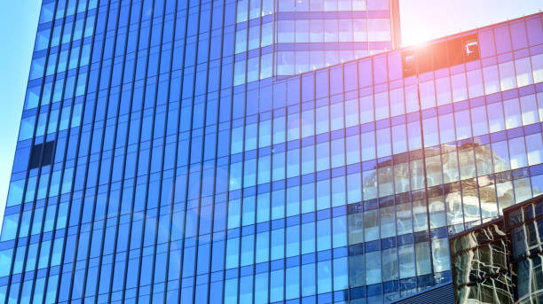 istock Commercial building close up in blue tone. Gigantic skyscraper from below. 1362329587