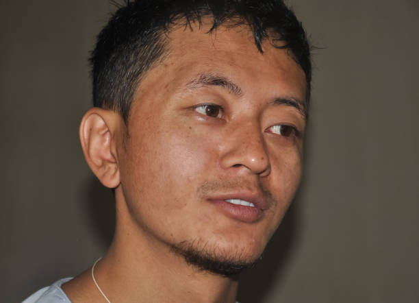 Closeup shot of a Asian guy face with looking sideways