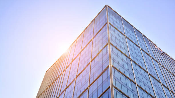 istock Commercial building close up in blue tone. Gigantic skyscraper from below. 1362330318