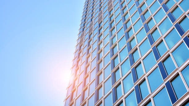 istock Commercial building close up in blue tone. Gigantic skyscraper from below. 1362330353