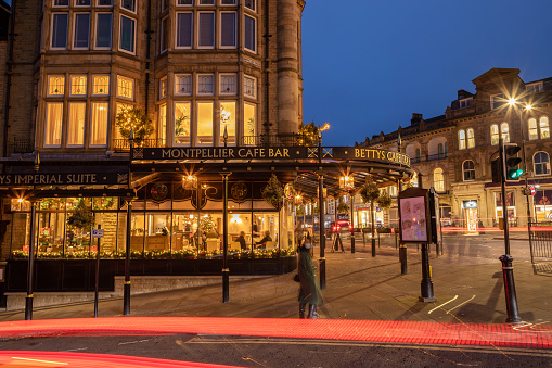 Christmas at night in the city of Harrogate in North Yorkshire, England. A street scene with the famous Betty restaurant and food shop.