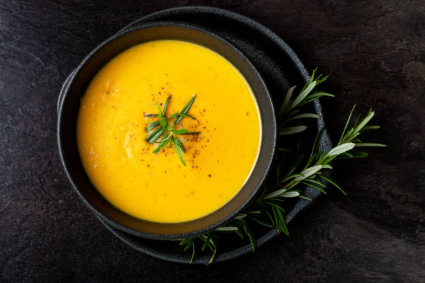 istock Pumpkin soup with linen napkin on dark background. 1362336427