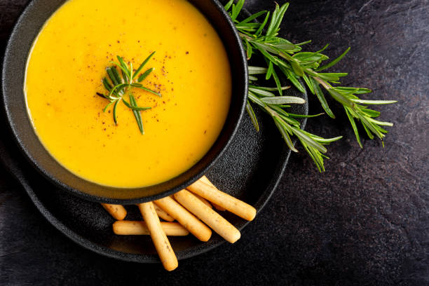 istock Pumpkin soup with linen napkin on dark background. 1362336982