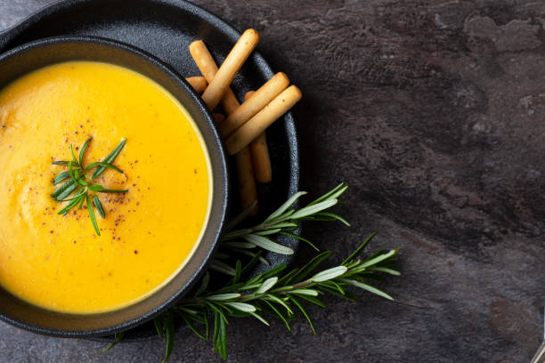 istock Pumpkin soup with linen napkin on dark background. 1362337000