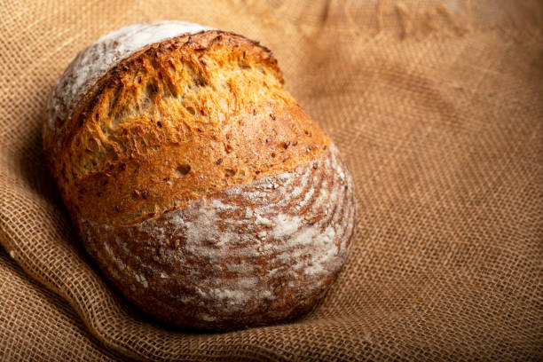 istock Wholemeal sourdough bread isolated on burlap cloth. 1362337084