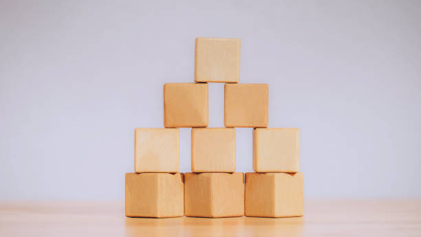 istock Stacking blank wooden cubes or arrange the wooden blocks on table for input wording and infographic icon. Business concept growth success process, ladder of success, Driving business at peak concept. 1362337168