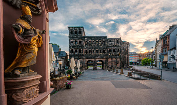 Saint Nicolas as foreground in the view of the World Heritage Site Porta Nigra in Trier Saint Nicolas as foreground in the view of the World Heritage Site Porta Nigra in Trier rhineland palatinate photos stock pictures, royalty-free photos & images