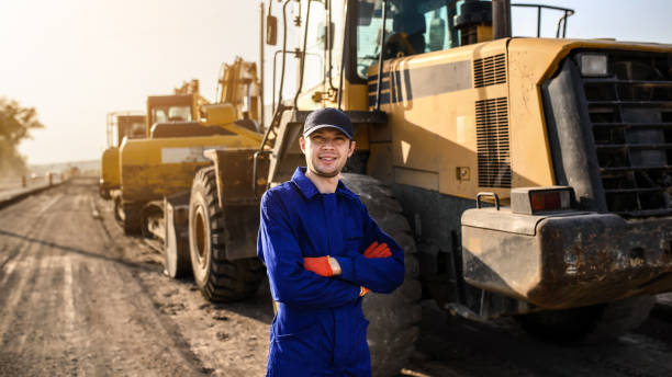 istock Young happy smiling man contractor builder in blue overalls is looking to the camera. 1362344152