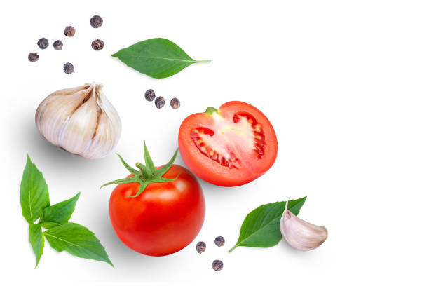 istock Tomato with basil leaves, garlic and black pepper isolated on white background. 1362346419