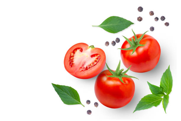 istock Tomato with basil leaves and black pepper isolated on white background. 1362346421