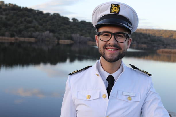 Ship captain with elegant uniform Ship captain with elegant uniform. sailor hat stock pictures, royalty-free photos & images