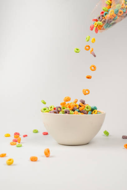 istock Colorful cereal box for morning breakfast. Corn flakes falling to the white bowl. Motion. 1362347428