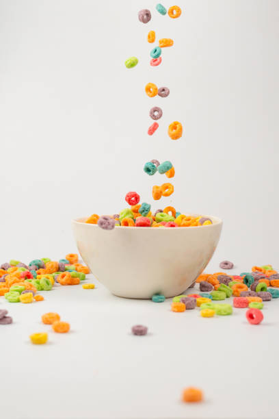 istock Colorful cereal box for morning breakfast. Corn flakes falling to the white bowl. Motion. 1362347433