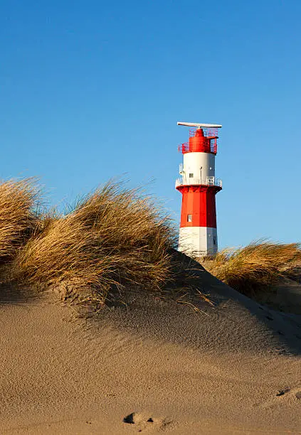 dunes and small lighthouse at south beach of Borkum island