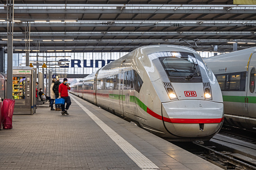 Modern bullet train at the main railway station in the middle of the German city Munich. The station (München Hauptbahnhof) is an example of the order and cleanliness many people connect with Germany.