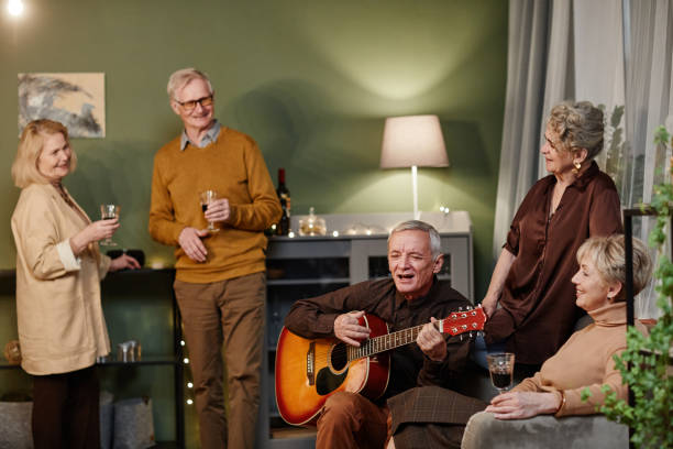 istock Old man playing guitar and singing 1362353798