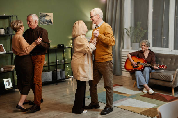 istock Seniors dancing while woman playing guitar 1362353821