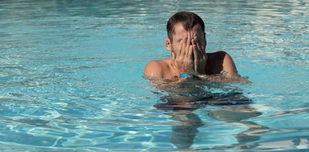 istock Man in the water pool covered face with his hand. 1362359128