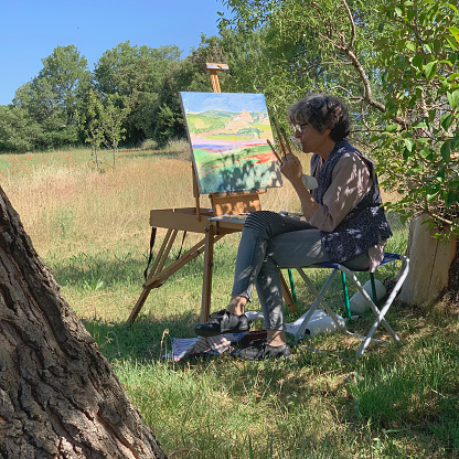 Artist at her easel, outdoors